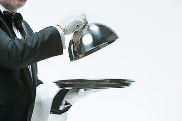 Image showing Close up waiter hand with tray and metal cloche lid cover