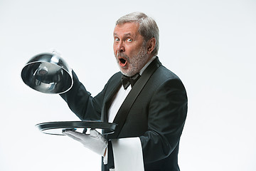 Image showing The waiter with tray and metal cloche lid cover