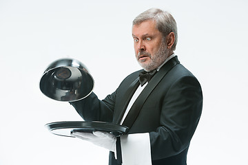 Image showing The waiter with tray and metal cloche lid cover