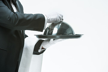 Image showing Close up waiter hand with tray and metal cloche lid cover