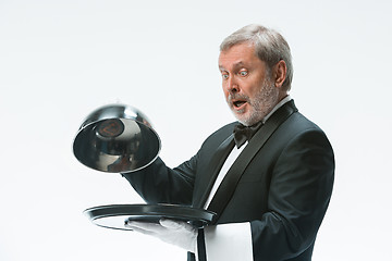 Image showing The waiter with tray and metal cloche lid cover