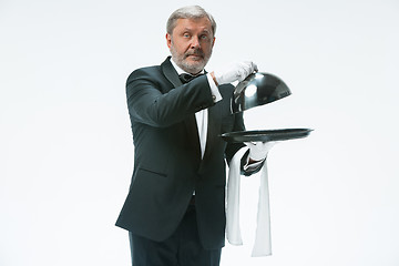 Image showing The waiter with tray and metal cloche lid cover