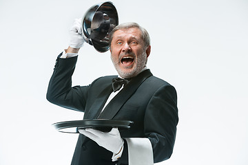 Image showing The waiter with tray and metal cloche lid cover