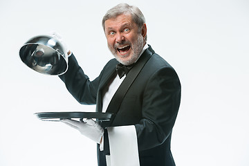 Image showing The waiter with tray and metal cloche lid cover