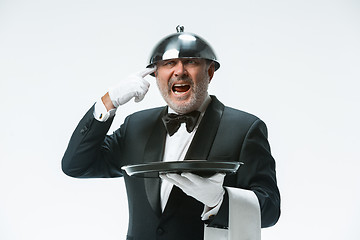 Image showing The waiter with tray and metal cloche lid cover