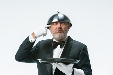 Image showing The waiter with tray and metal cloche lid cover