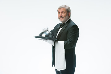 Image showing The waiter with tray and metal cloche lid cover