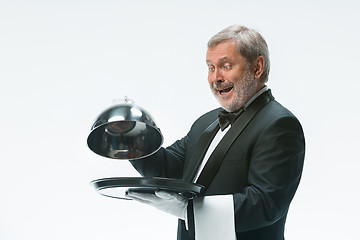 Image showing The waiter with tray and metal cloche lid cover