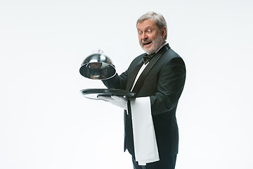 Image showing The waiter with tray and metal cloche lid cover