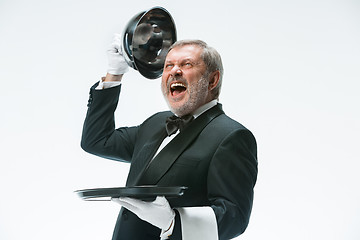 Image showing The waiter with tray and metal cloche lid cover