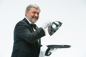 Image showing The waiter with tray and metal cloche lid cover