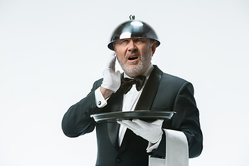 Image showing The waiter with tray and metal cloche lid cover