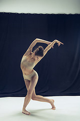 Image showing Young teen dancer ion white floor background.