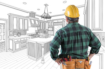 Image showing Male Contractor with Hard Hat and Tool Belt Looking At Custom Ki