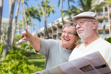 Image showing Happy Senior Adult Couple Tourists with Brochure Next To Tropica