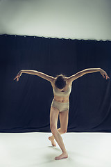 Image showing Young teen dancer ion white floor background.