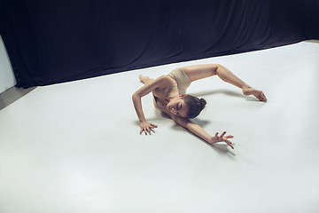 Image showing Young teen dancer ion white floor background.