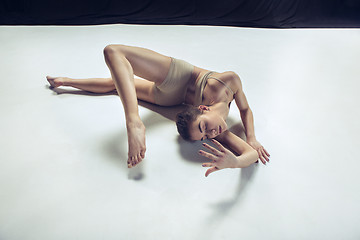 Image showing Young teen dancer ion white floor background.