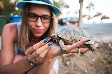 Image showing woman feeding turtle