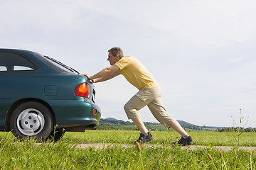 Image showing Man pushing his car