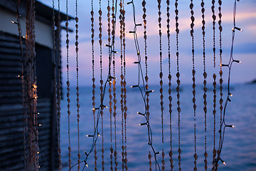 Image showing Strings of seashells and christmas lights