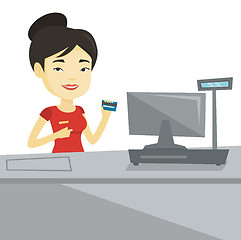 Image showing Cashier holding credit card at the checkout.