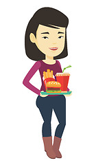 Image showing Woman holding tray full of fast food.