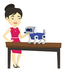 Image showing Happy young woman playing with robotic dog.