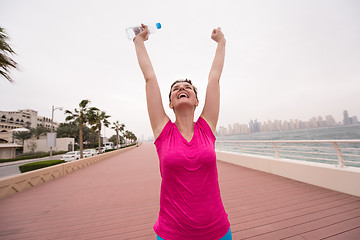 Image showing young woman celebrating a successful training run