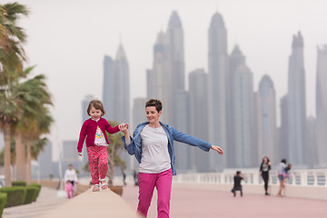 Image showing mother and cute little girl on the promenade