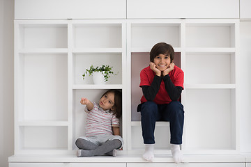 Image showing young boys posing on a shelf