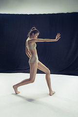 Image showing Young teen dancer ion white floor background.