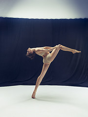 Image showing Young teen dancer ion white floor background.