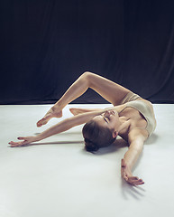 Image showing Young teen dancer ion white floor background.