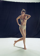 Image showing Young teen dancer ion white floor background.