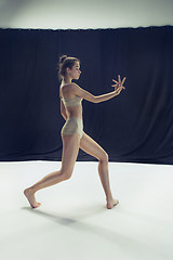 Image showing Young teen dancer ion white floor background.