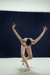 Image showing Young teen dancer ion white floor background.