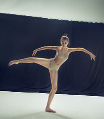 Image showing Young teen dancer ion white floor background.