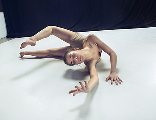 Image showing Young teen dancer ion white floor background.