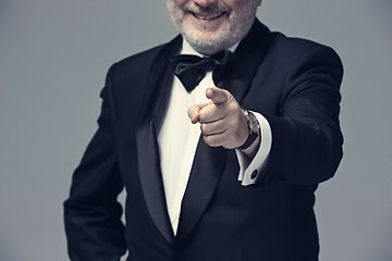 Image showing Senior Businessman standing and pointing to camera