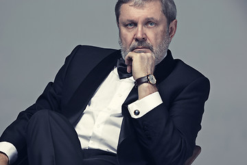 Image showing Senior Businessman sitting in chair