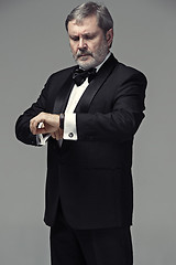 Image showing Middle aged male adult wearing a suit isolated on gray