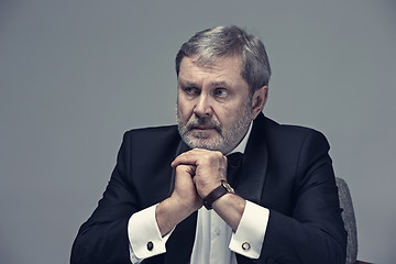 Image showing Senior Businessman sitting in chair