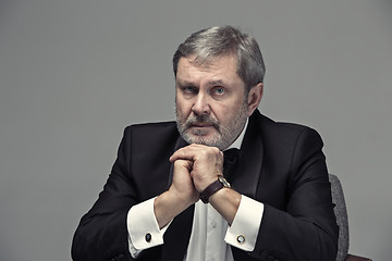 Image showing Senior Businessman sitting in chair