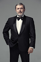 Image showing Middle aged male adult wearing a suit isolated on gray