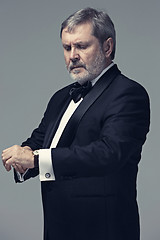 Image showing Middle aged male adult wearing a suit isolated on gray