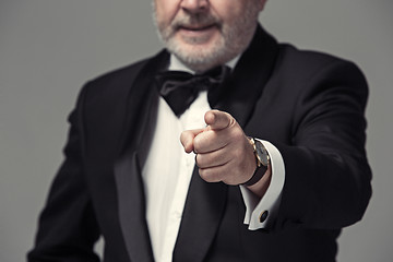 Image showing Senior Businessman standing and pointing to camera