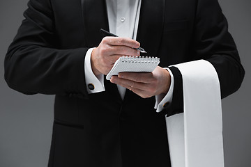 Image showing Waiter taking an order wearing a waistcoat in a fancy restaurant