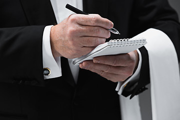 Image showing Waiter taking an order wearing a waistcoat in a fancy restaurant