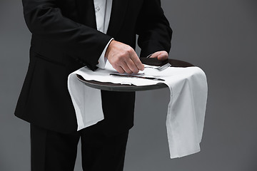 Image showing Senior waiter holding tray